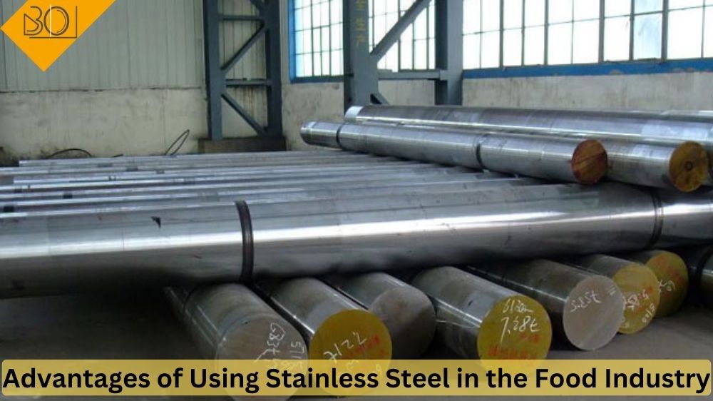 Stainless steel bars arranged neatly in a factory setting, showcasing industrial manufacturing processes and materials.