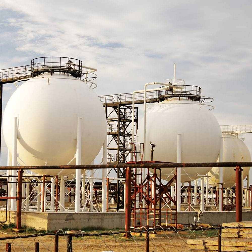 Industrial landscape with large white oil tanks, showcasing infrastructure